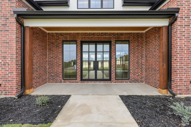Covered front entry with glass doors at 2069 Preserve Trail by M2 Luxury Homes in Timberview Preserve