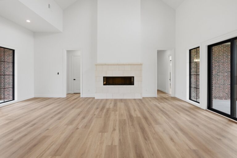 Vaulted living room with fireplace at 2069 Preserve Trail by M2 Luxury Homes in Timberview Preserve