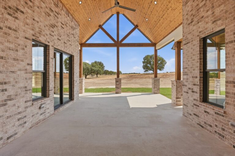 Covered patio with vaulted timber ceiling at 2077 Preserve Trail by M2 Luxury Homes in Timberview Preserve