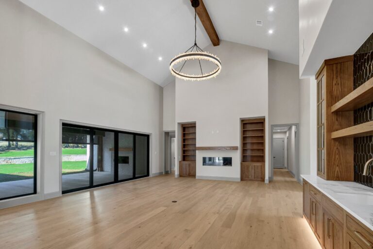 Great room with arched ceiling and floating fireplace at 519 Royal Santana Run