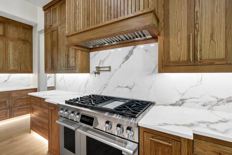 Kitchen with white oak cabinetry and commercial-grade range hood at 519 Royal Santana Run
